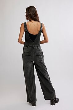 Cool in corduroy, these classic overalls are perfect for layering with your favorite intimates. **Fit:** Relaxed, wide-leg fit **Features:** Surplice wrap bodice, adjustable brace straps, pouch pockets, textured corduroy fabrication **Why We ❤ It:** Toughened up with moto boots or off-duty with court sneakers, this style has endless ways to wear. | Mara Cord Overalls by Free People in Black, Size: US 6 Cord Overalls, Black Overalls, Moto Boots, Off Duty, Pocket Pouch, Bodice, Layering, Overalls, Wide Leg