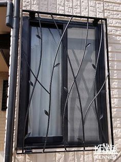 a window with metal bars on the side of it