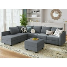 a living room with a sectional couch and ottoman