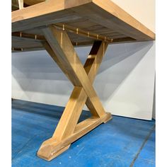 a wooden table sitting on top of a blue floor