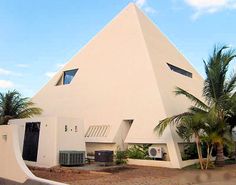 a large white building with a triangular roof