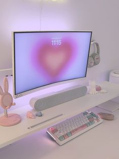 a computer monitor sitting on top of a white desk next to a keyboard and mouse