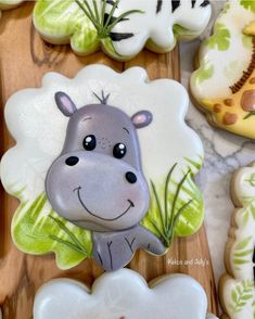 cookies decorated like animals and plants on a table