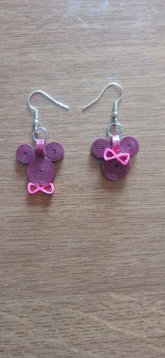 pair of pink and purple butterfly earrings on wooden table with earwires in the shape of hearts