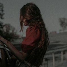 a woman with long hair is holding a horse