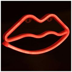 a red neon sign that is lit up in the dark with its mouth open and tongue out