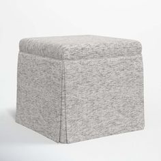 a grey ottoman with a white background