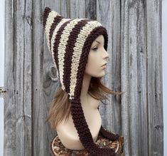 Knit Hat Style: Pixie Hat - a chunky bonnet with a pointed crown and knitted ties, for women, men and teens. Color: This sample hat is shown in wide stripes of Oatmeal and Redwood, a burgundy/brown. Sizes: One size fits average teen or adult head size of 20" to 23" (50.5 cm to 58 cm). Fiber Content: 80% acrylic, 20% wool Characteristics: Whimsical, chunky, very soft, warm and cozy.  Care Instructions: Hand wash, dry flat.  Every item from Pixiebell is handmade and knit or crocheted to order, unl Chunky Knit Hat, Pixie Hat, Handmade Knitwear, Knitted Hood, Pattern Store, Skull Cap Beanie, Skull Cap, Knit Or Crochet, Chunky Knit