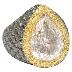 De Grisogono Ring set with a pear shape diamond of 10.85 carats, color I, purity SI2, from the best Belgium laboratory, HRD certificated, surrounded by Fancy yellow and black diamonds, on a white gold ring, size 9 ¼ (28,9grs) This ring is a unique piece specially designed for this diamond by De Grisogono house. Grisogono Jewelry, Dome Rings, Pear Shape Ring, Pear Cut Diamond Ring, Pear Cut Ring, Diamond Gold Ring, Pear Shaped Ring, Black Gold Jewelry, Bracelets Design