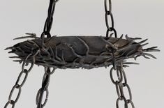 a metal object with chains attached to it