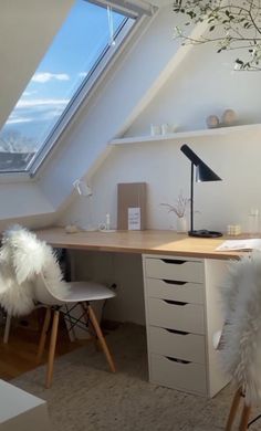 an attic bedroom with a desk and chair