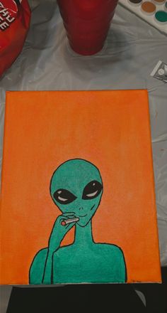 an alien painting is shown on the table