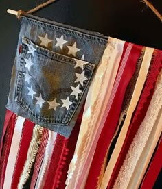 an american flag made out of old jeans hanging on a rope