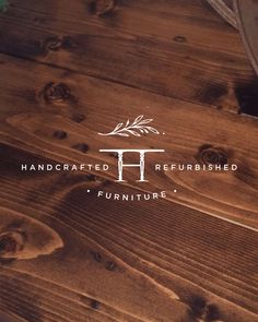 the logo for handcrafted refrished furniture on a wooden table with green leaves