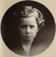 an old black and white photo of a young boy with blonde hair in a round frame