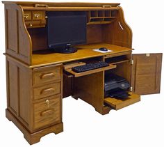 an old fashioned computer desk with two drawers and a monitor on the left side of the desk