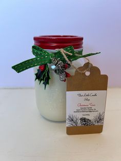 a mason jar filled with christmas decorations and a tag