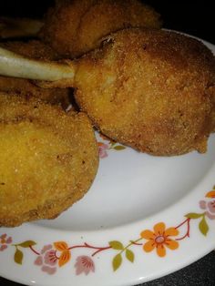 two fried food items on a plate with flowers