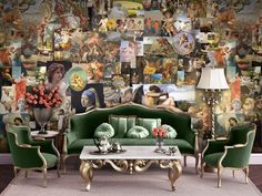 a living room filled with green couches and pictures on the wall behind them in front of a coffee table