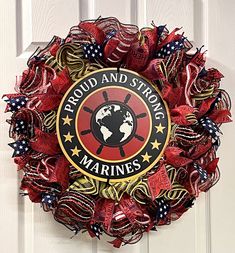 a wreath with the words proud and strong marines on it is hanging on a door