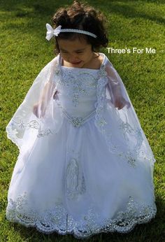 Our Virgin Mary Embroidered Baptism Collection is here!All our dresses are made here in the United States.A 3 pcs dress: includes dress, cape and headband.Our dresses are made of satin and organza.We use satin on our beautiful dresses and organza on capes.Dresses are true to size, corset on sides to adjust for perfect fit. A large Virgin Mary Embroidery on skirt of dressSpaghetti strap make our dresses fresh for any sunny summer baptism Hope you love it as much as we do!Sizes:12 monthsLength:25- Virgin Mary Embroidery, Baptism Dress Girl, Mary Embroidery, White Baptism Dress, Vestido Charro, Bautizo Ideas, Baptism Dresses, Girls First Communion Dresses, Baby Baptism Dress