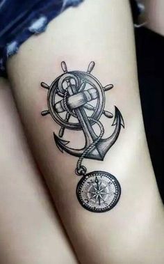 an anchor and compass tattoo on the arm