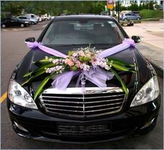 a car decorated with flowers and ribbons