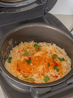 a pot filled with rice covered in sauce and garnished with cilantro