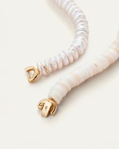 A series of sustainably-sourced shells and donut pearls encircle the neck in an elevated way, with a nautilus closure that can be worn in the front or the back.Using the foldover closure: Look for the JENNY BIRD logo on the flat bar. On one side, you’ll see a hinge, on the other side, you’ll see a tab. Gently pull the tab upward to open. To close, thread the tab closure through the opening, and press firmly to close. You will hear it click into place. 14K gold ion plated steelfreshwater pearlssh Nautilus Jewelry, Necklace Clasp, 14k Gold Ear Cuff, Crystal Bead Jewelry, Jenny Bird, Bird Logos, Gold Ear Cuff, Bar Studs, Necklace Clasps