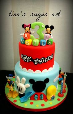 a birthday cake with mickey mouse decorations on it