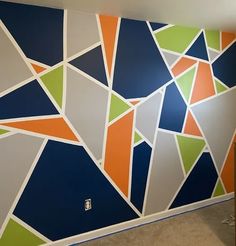 the wall is painted with different colors and shapes