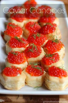 small pastry with red caviar candies on top and green sprigs in the middle