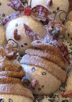 several snowmen made out of doughnuts with bows on them