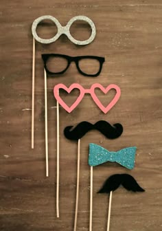 three mustaches, glasses and bow tie on sticks