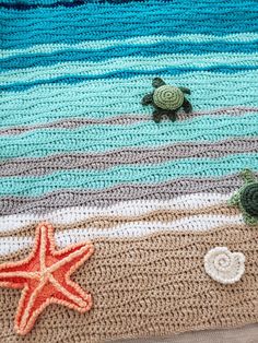 crocheted blanket with turtle and starfish on the beach