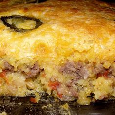 a close up of a pie with meat and cheese on it's crusts