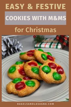 cookies with m & m's for christmas on a white plate and pine cones