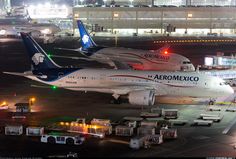 two airplanes are parked on the tarmac at an airport