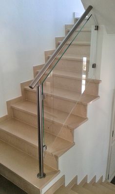 a set of stairs with glass handrails