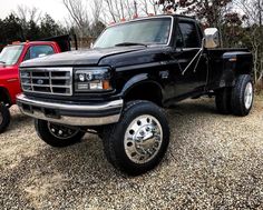 a black pick up truck parked in gravel