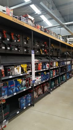 the inside of a store with shelves full of tools