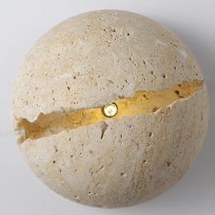 a round object with a hole in the middle and a gold ring on it's end