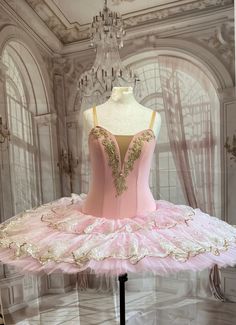 a pink ballerina dress on display in a room