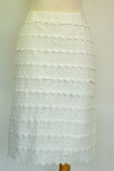 This vintage Lilly Pulitzer skirt is made of layers of white cotton embroidered eyelet lace. Both the lace and the lining are 100% cotton. The skirt closes down the back with a 7 inch invisible zipper. Size 6. Please see measurements.   -Measurements:      -Waist: 30 inches     -Hips: 41 inches     -Width at hem: 42 inches White Crochet Lace Summer Skirt, White Crochet Lace Skirt For Summer, White Broderie Anglaise Cotton Skirt, White Cotton Skirt With Broderie Anglaise, White Scalloped Lace Skirt, Fitted White Skirt With Lace Work, Fitted White Lace Skirt, White Broderie Anglaise Tiered Skirt, White Long Lace Skirt