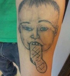 a person with a tattoo on their arm has a drawing of a man's face