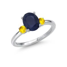 an oval blue and yellow sapphire ring with two diamonds on the sides, set in white gold