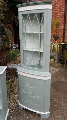 an old china cabinet painted in blue and white with the words marie de poulevre written on it