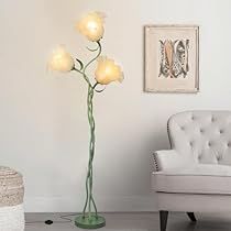 a white chair sitting next to a lamp in a living room