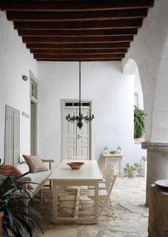 a table and chairs in a room with white walls