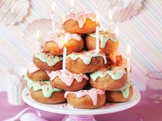 a pile of donuts sitting on top of a white plate covered in frosting